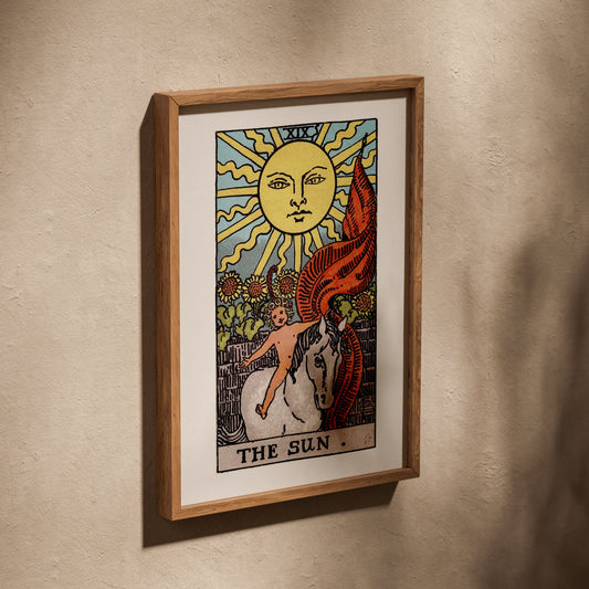 Le Soleil - Arcane XIX du Tarot Rider-Waite, affiche dans un cadre en chêne posé de biais sur un mur texturé