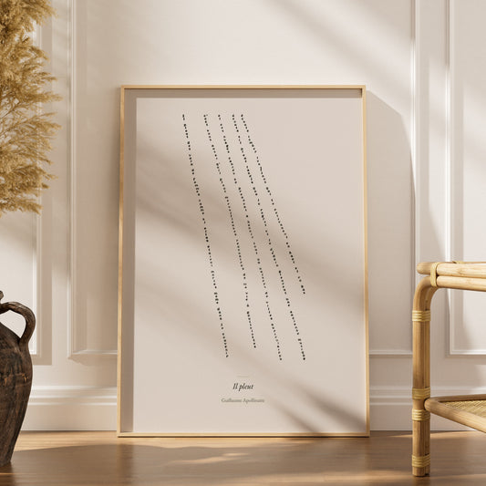 Il pleut, calligramme de Guillaume Apollinaire, affiche encadrée posée dans un intérieur clair