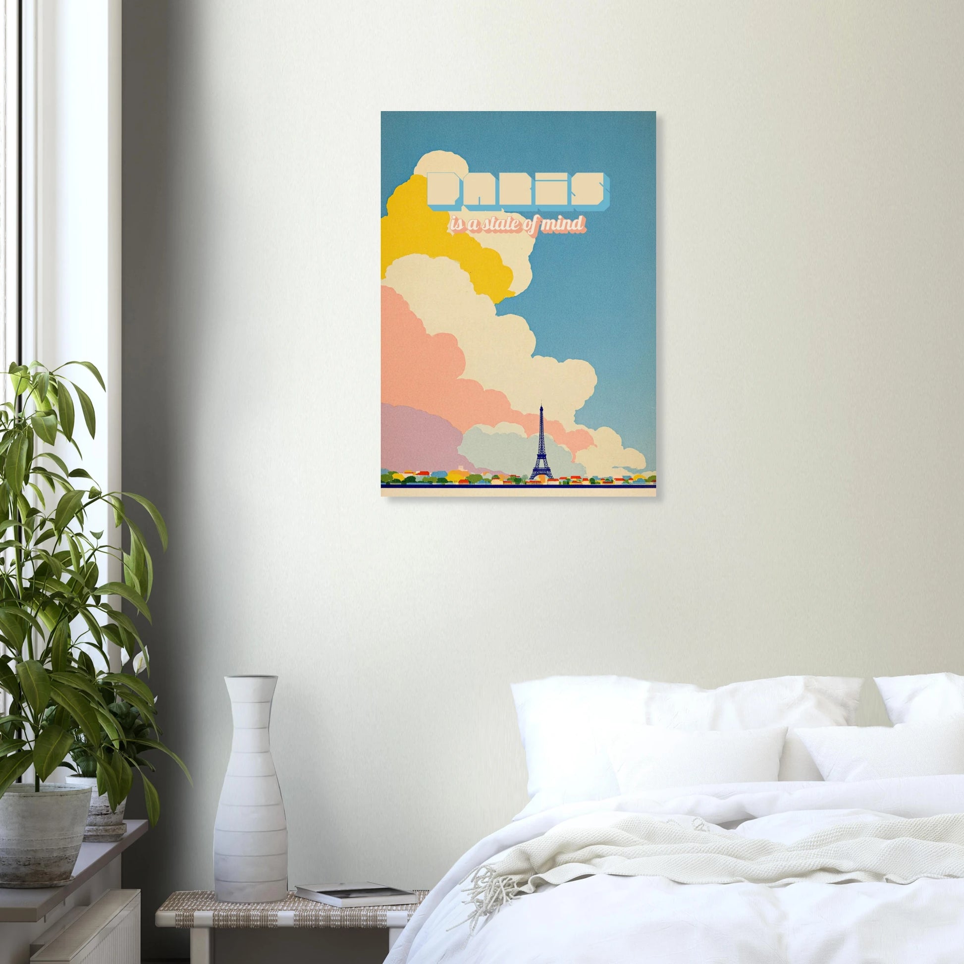 Modern bedroom with Paris wall art, Eiffel Tower print, pastel clouds, indoor plant and white bedding.