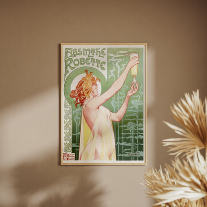 Absinthe Robette - Privat-Livemont, affiche encadrée sur un mur beige, pampas au premier plan