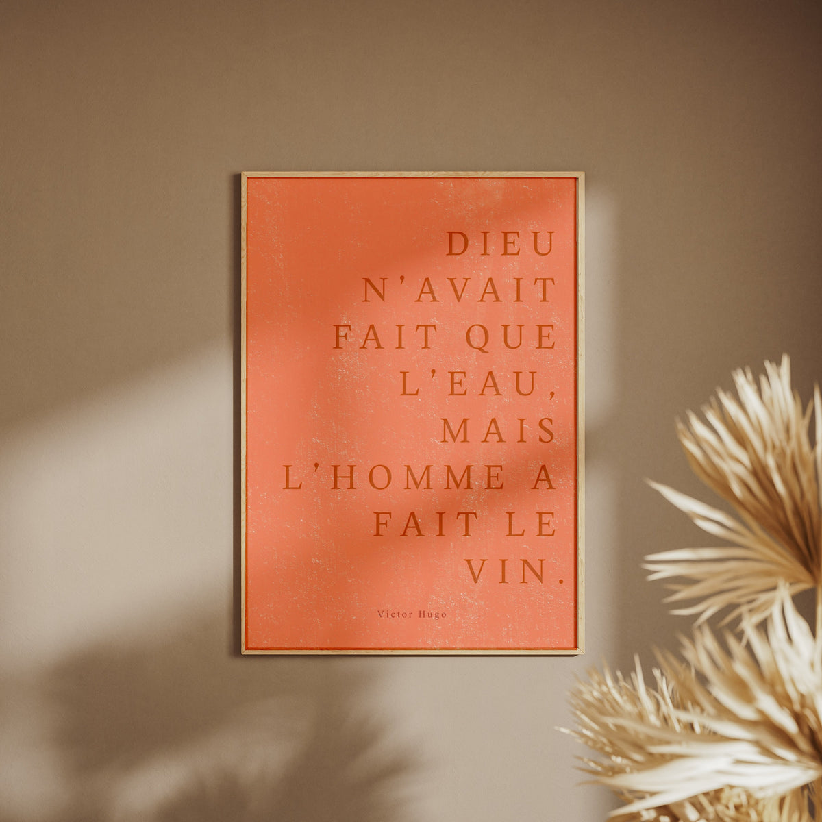 ...Mais l’homme a fait le vin. | Poster Citation, affiche encadrée sur un mur beige, pampas au premier plan