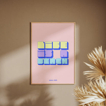Life is a beach graphic poster, framed poster on a beige wall, pampas grass in the foreground