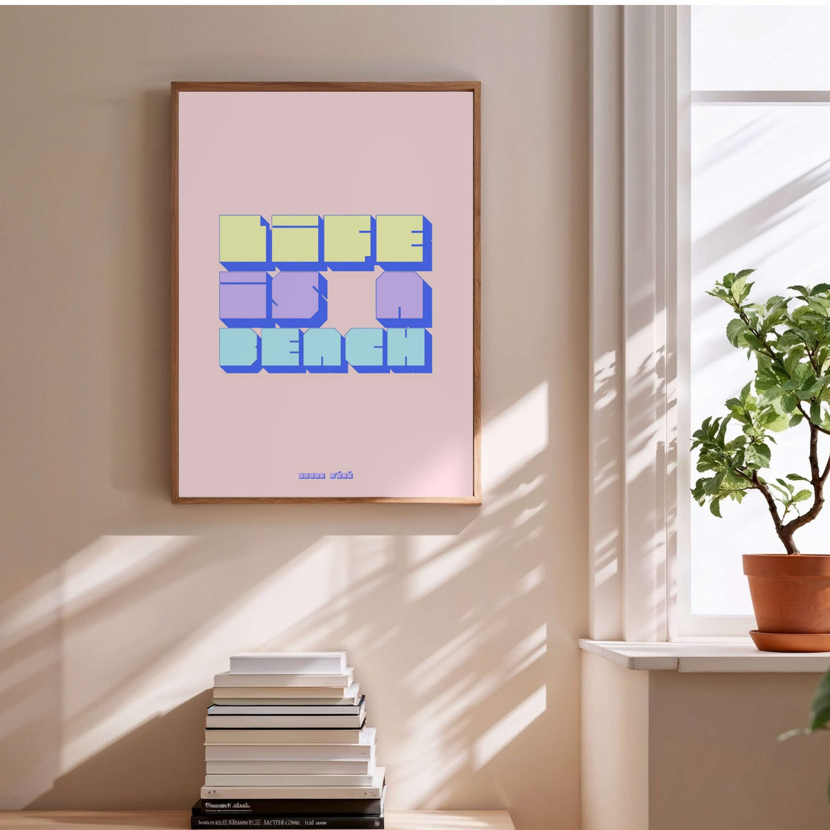 Life is a beach graphic poster, framed poster above a stack of books