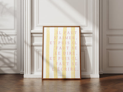Affiche citation Victor Hugo « Il faut s'aimer, et puis il faut se le dire, et puis il faut se l'écrire » sur rayures jaunes, posée contre un mur à moulures
