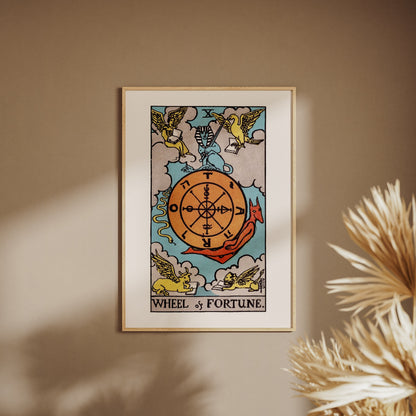 The Wheel of Fortune - Arcana X of the Rider-Waite Tarot, framed poster on a beige wall, pampas grass in the foreground