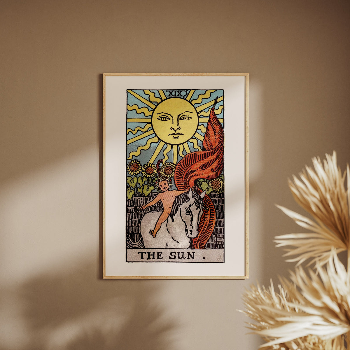 Arcanum XIX - The Sun - Rider-Waite-Smith Tarot Poster, framed poster on a beige wall, pampas grass in the foreground
