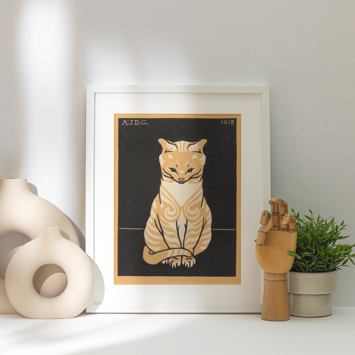 Chat Assis - Julie de Graag - Affiche Art Animalier, affiche encadrée posée près d'un vase blanc, lumière rasante