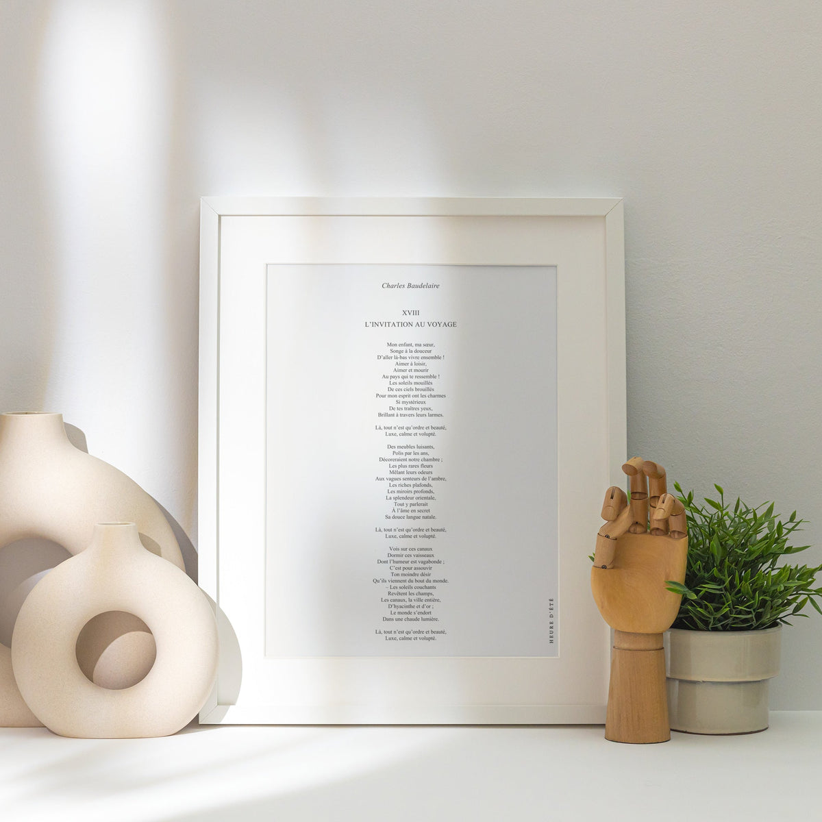 Affiche L'Invitation au voyage, poster poème Baudelaire, affiche encadrée posée près d'un vase blanc, lumière rasante