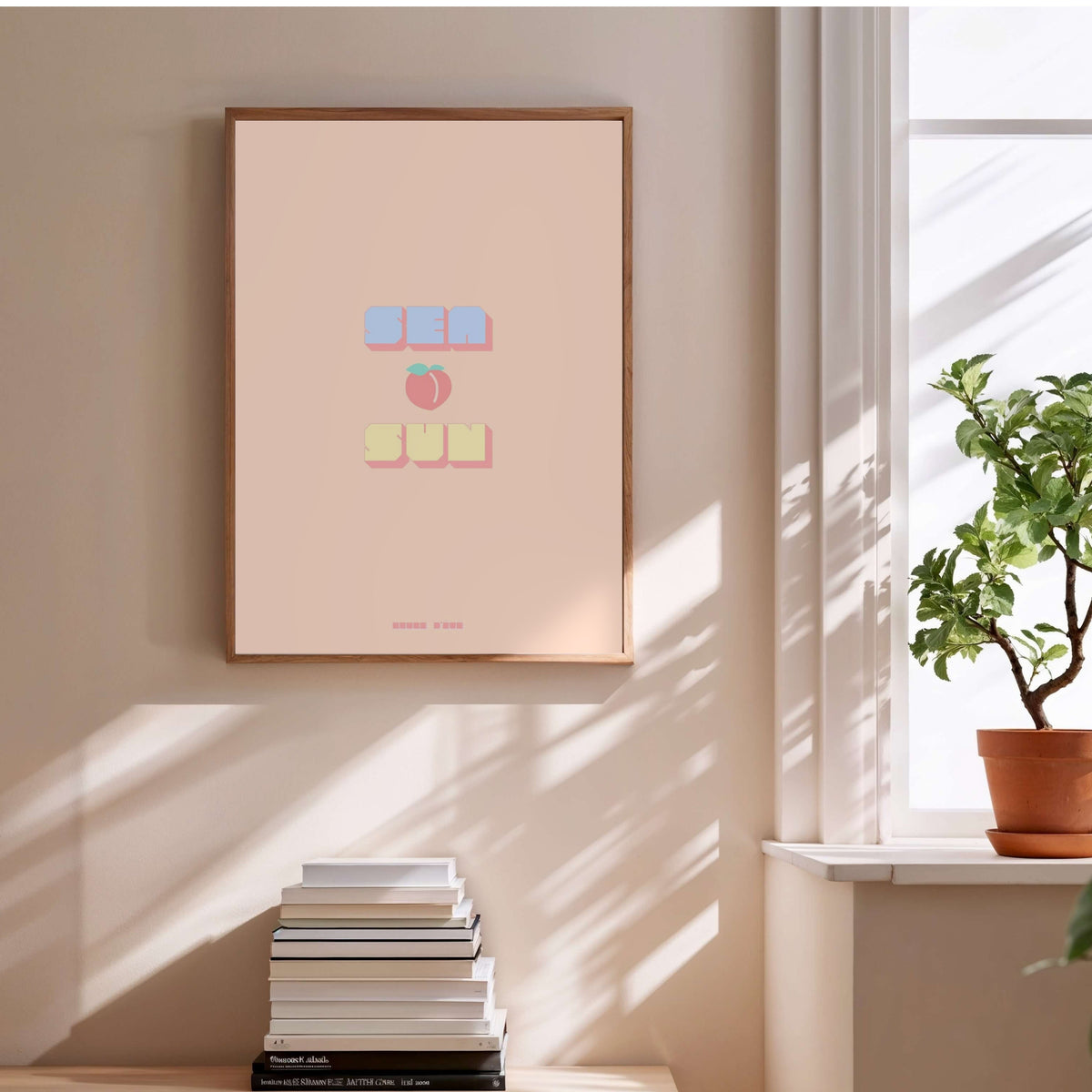 Sea Peach &amp; Sun Poster, framed poster above a stack of books