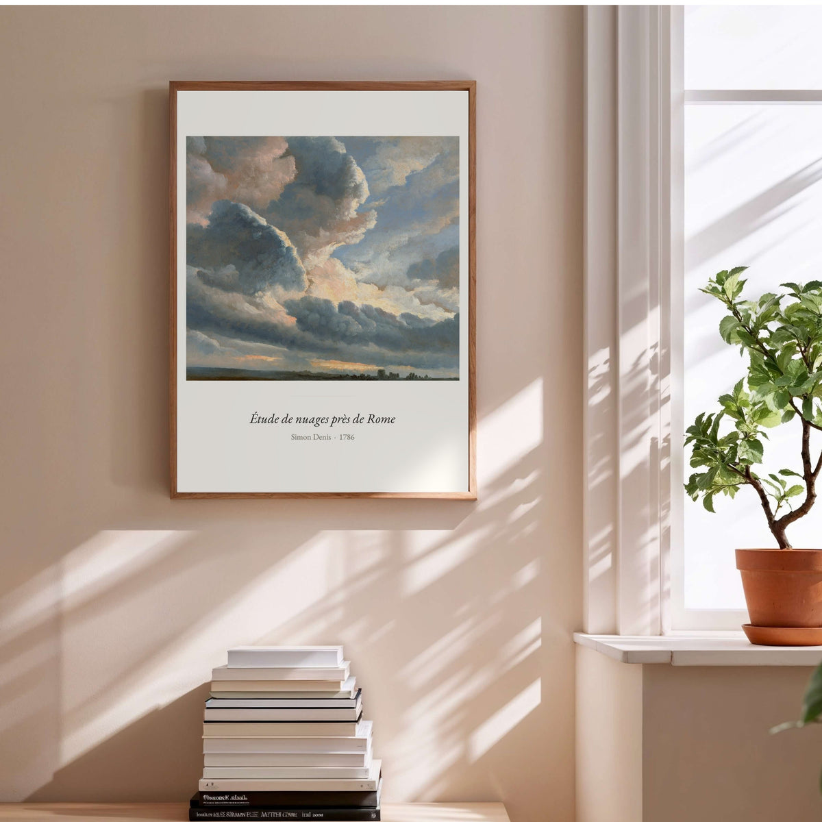 Étude de nuages près de Rome, Simon Denis, affiche encadrée au-dessus d'une pile de livres