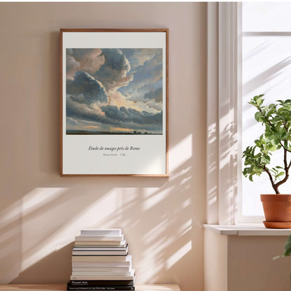 Étude de nuages près de Rome, Simon Denis, affiche encadrée au-dessus d'une pile de livres
