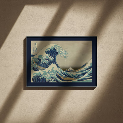 Hokusai Great Wave print, 24x16 in fine art, framed on a textured wall in raking light