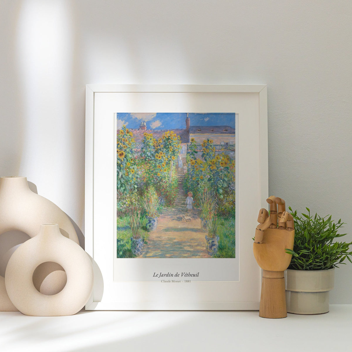 Le Jardin de Vétheuil, Claude Monet, affiche encadrée posée près d'un vase blanc, lumière rasante