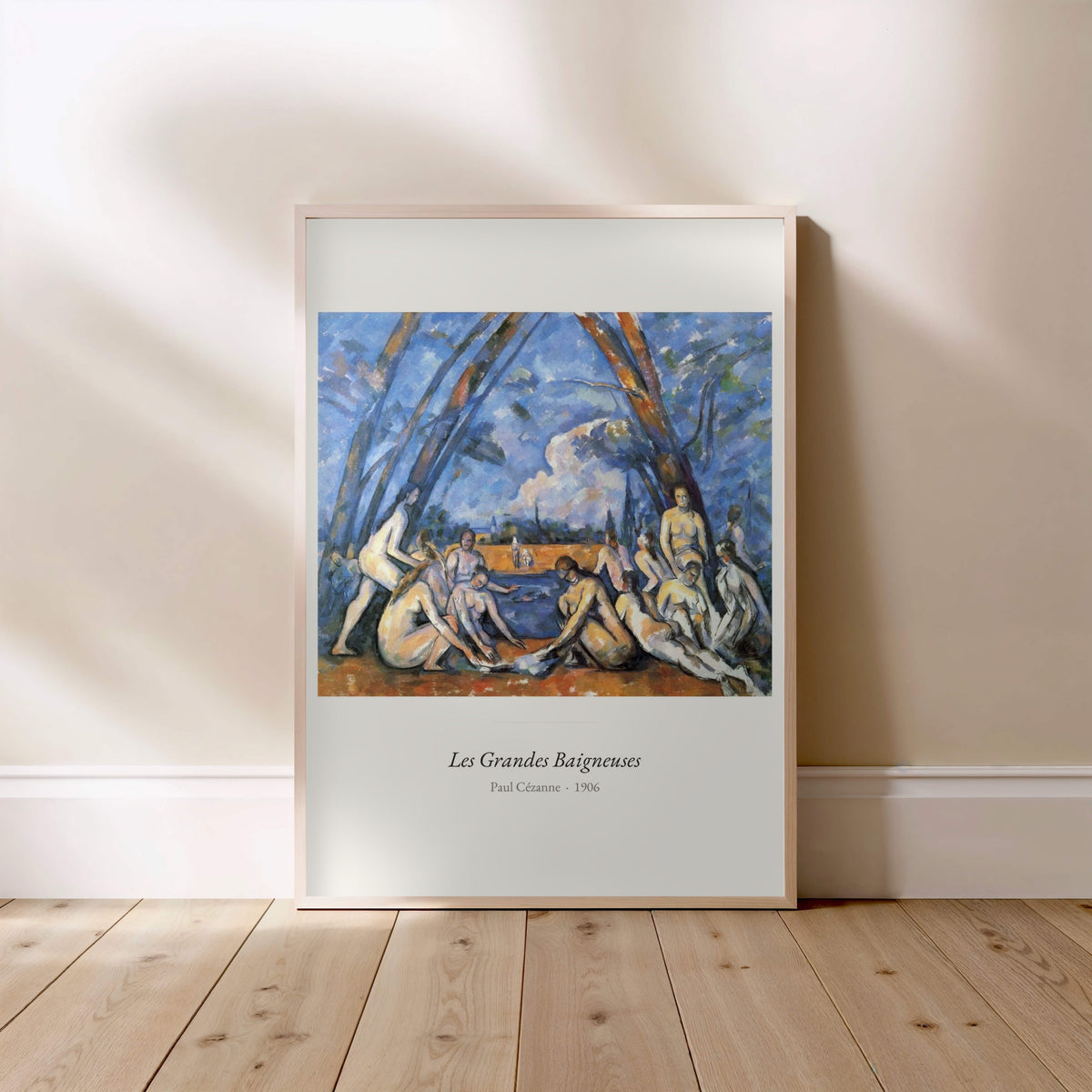 Les Grandes Baigneuses, Paul Cézanne, affiche encadrée posée au sol, cadre bois clair