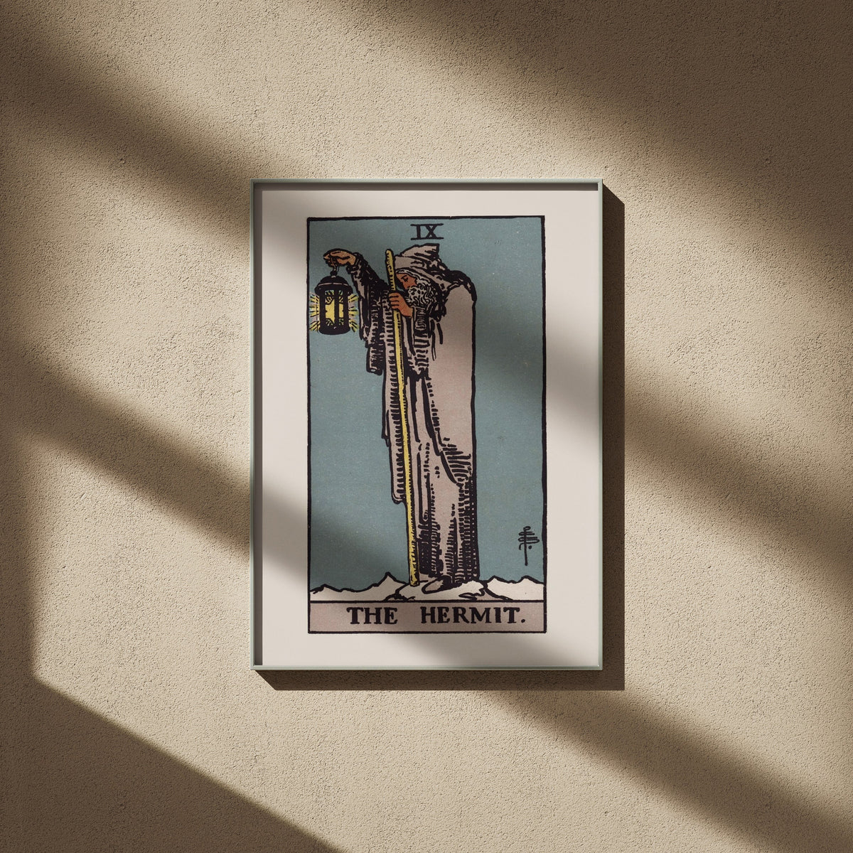 The Hermit, IX: Rider-Waite tarot print, 20x28, framed on a beige wall with window shadows