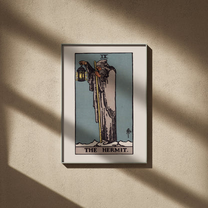 The Hermit, IX: Rider-Waite tarot print, 20x28, framed on a beige wall with window shadows