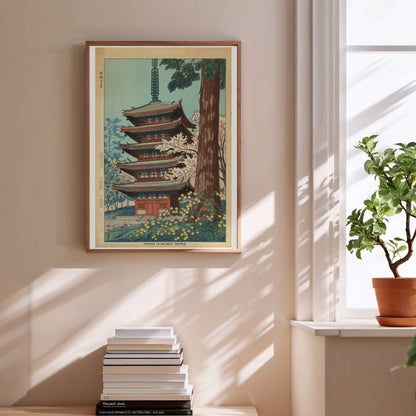 Printemps au Temple Daigoji - Asano Takeji, affiche encadrée au-dessus d'une pile de livres