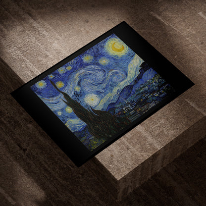Van Gogh Starry Night fine art print lying on a concrete block in evening light